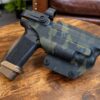 Level II retention OWB holster in MultiCam Black kydex molded for a Canik pistol with weapon light